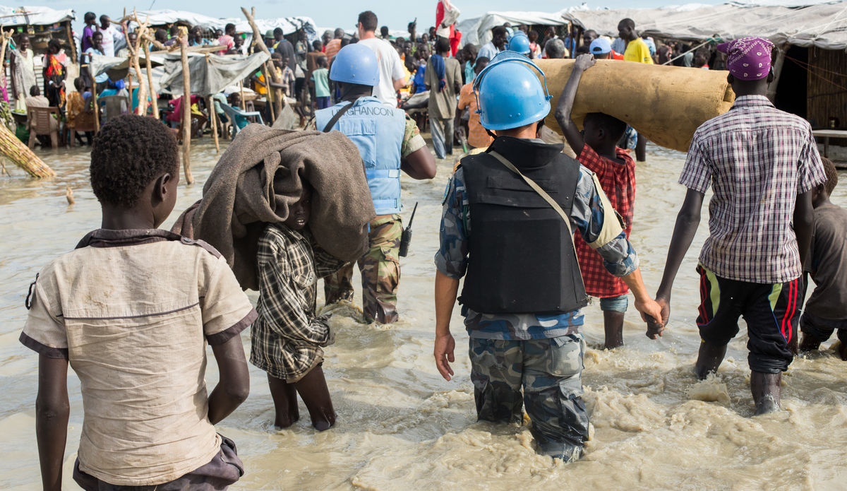Displaced people living in flooded protection site.