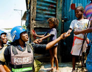 Nigerian FPU Officers speak with children as they patrol the slum of Martissant