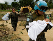 MINUSTAH also worked to help Haitians during a number of natural disasters over the past 13 years, including heavy rains from tropical storm Noel in 2007, which left thousands of people homeless. Above, a Brazilian UN peacekeeper rescues a baby and his family from a flooded home in Cite Soleil.